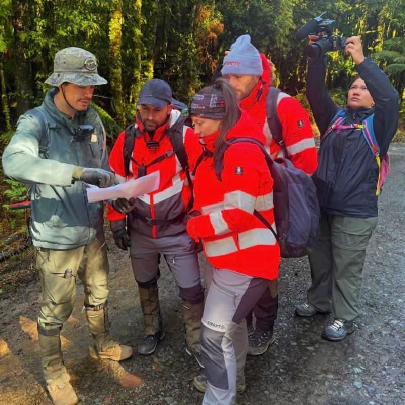 Rob Parsons (left) with searchers looking for Celine Cremer in bushland in Tasmania's north-west in December.