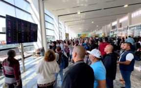 Travelers look for information at Guadalajara International Airport.