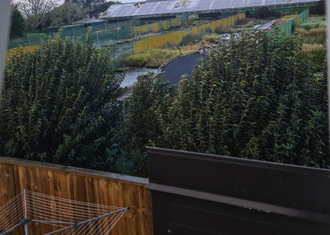 A trampoline was blown over this fence in Pukekohe.