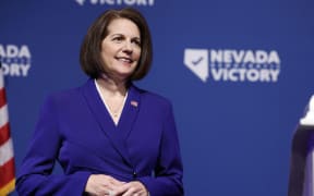 (FILES) In this file photo taken on November 8, 2022 U.S. Sen. Catherine Cortez Masto (D-NV) listens as Nevada Gov. Steve Sisolak speaks at an election night party hosted by Nevada Democratic Victory at The Encore in Las Vegas, Nevada. - President Joe Biden's Democrats retained control of the US Senate on November 12, 2022, a remarkable midterms election result that defied predictions of a Republican "red wave" over both houses of Congress. (Photo by Anna Moneymaker / GETTY IMAGES NORTH AMERICA / AFP)