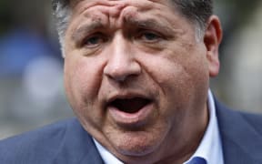 Illinois Governor JB Pritzker speaks as he takes a Chicago water taxi from Michigan Avenue stop, on the way to a press conference in Chicago, Illinois, on August 25, 2025. (Photo by KAMIL KRZACZYNSKI / AFP)