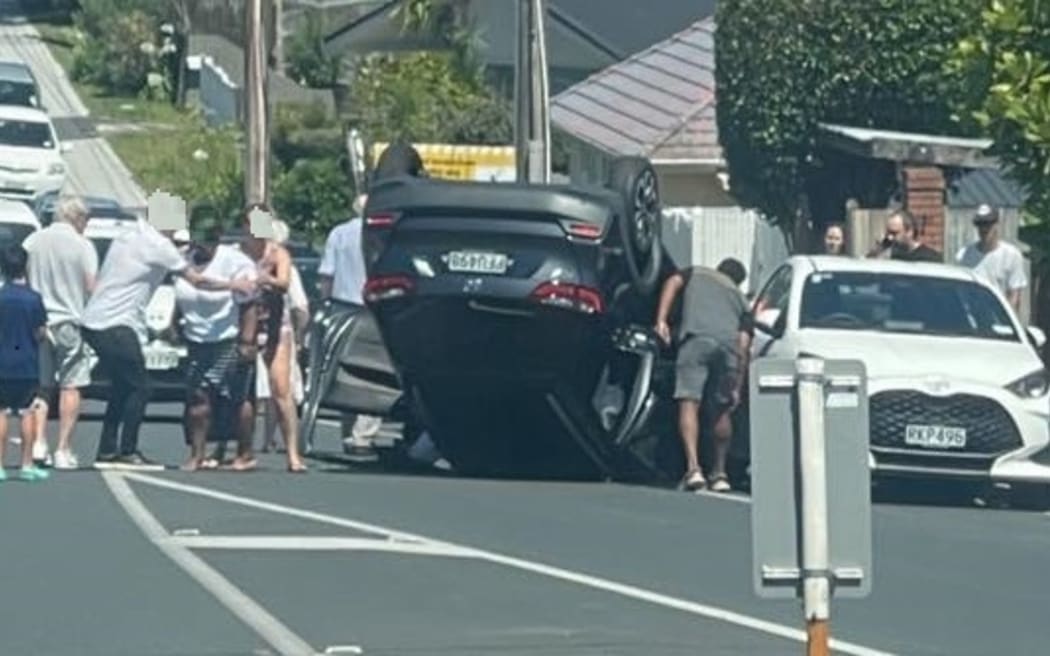 A car flips on Waipa St on Auckland's North Shore