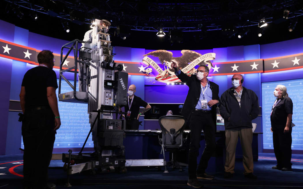 Members of the stage crew set up the debate hall ahead of the vice presidential debate in Kingsbury Hall of the University of Utah October 6, 2020 in Salt Lake City, Utah.