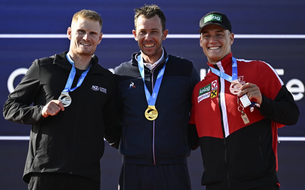 Silver medalist New Zealand's Finn Butcher, gold medallist France's Boris Neveu and bronze medalist Austria's Felix Oschmautz celebrate on the podium during the 2024 Olympic Games Test Event, Paris.