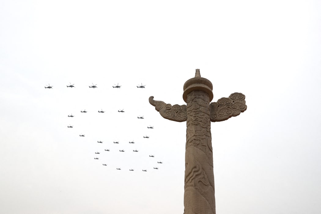 Helicopters fly over Tian'anmen Square in the formation of "100" ahead of a grand gathering celebrating the Communist Party of China centenary at Tian'anmen Square in Beijing, 1 July, 2021.