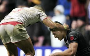 Kiwis fullback Roger Tuivasa-Sheck is comforted by an England player after losing the Test series decider at Wigan