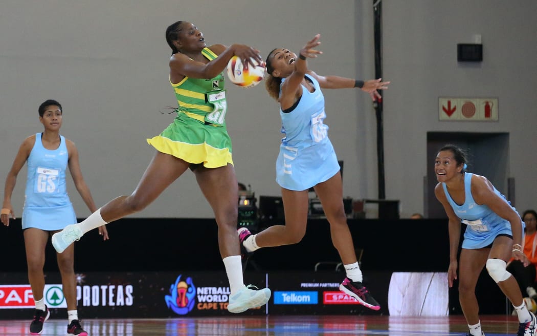 Claris Kwaramba of Zimbabwe and Unaisi Rauluni of Fiji challenge for possession during the Netball World Cup 2023 Pool A match between Zimbabwe and Fiji at Cape Town International Convention Centre Court 2 on July 29, 2023 in Cape Town, South Africa.