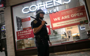 A New York City policeman stands guard on Broadway during a night of protests and vandalism over the death of George Floyd on June 1, 2020 in New York City.