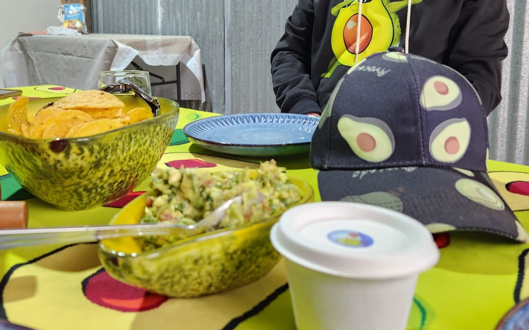 Produce featuring avocados on a table covered in an avocado print tablecloth