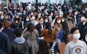 Many people wearing masks are seen at Shibuya scramble crossing in Tokyo on November 15, 2020.