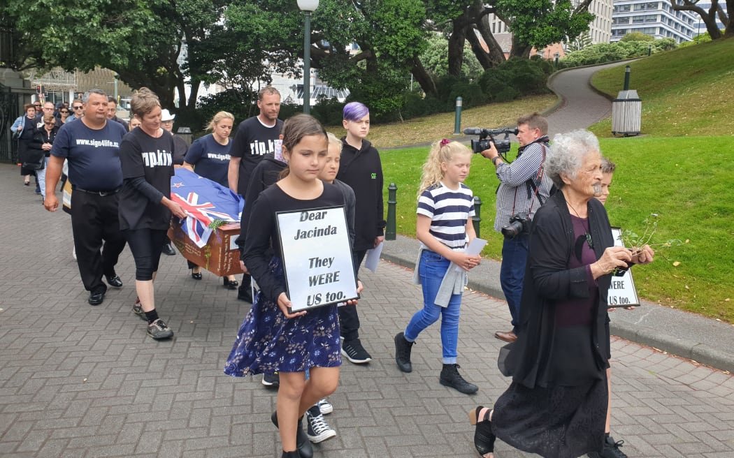 A mock funeral led by Julian and Camilla Cox who cycled from Dunedin to Wellington. Pictured outside Parliament.