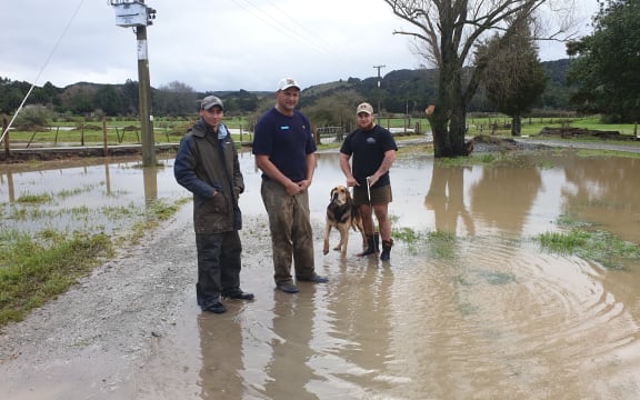 Sam Davis, centre, says three quarters of his Northland Dairy farm was underwater