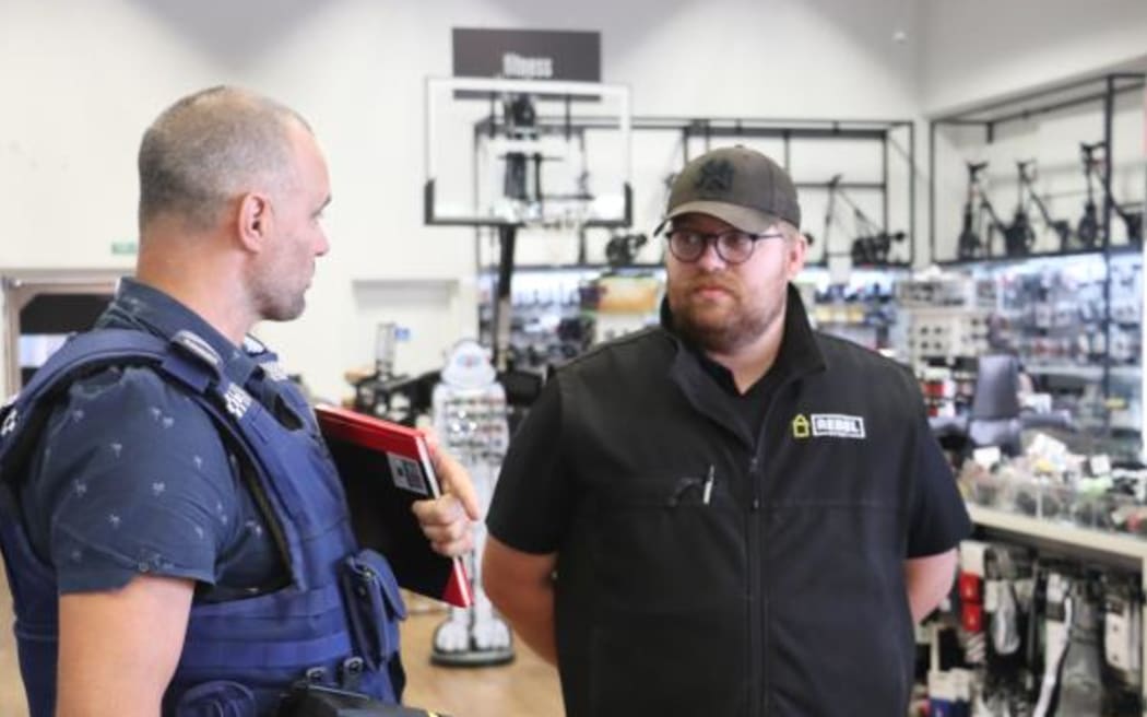 A police officer speaks to a retailer in Hawke's Bay during an operation aimed at arresting repeat shoplifting offenders