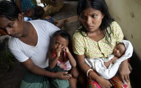 This photo taken on September 22, 2017 shows 20-year-old Hindu girl, Chaw Shaw Chaw Thee (R), who believes 23 members of her family are dead after Rohingya militants attacked their Hindu village in the Kha Maung Seik area of northern Rakhine in Myanmar.