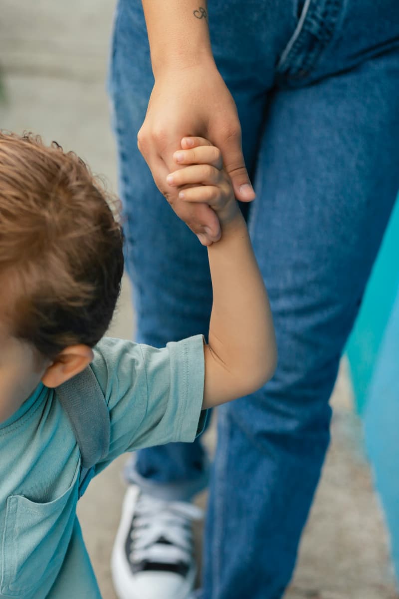Parent taking their child to school.