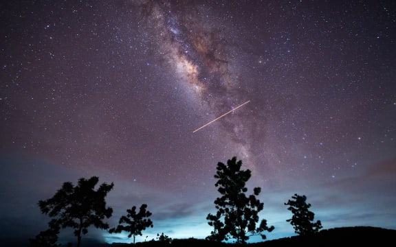 A flight-illuminated path and the Milky Way are appearing in the night sky during the Eta Aquarids meteor shower, which is peaking in Ratnapura, Sri Lanka, on May 5, 2024. The Eta Aquarids Meteor Shower is an annual event caused by Earth passing through debris left behind by Halley's Comet. Named after the constellation Aquarius, these meteors are streaking across the sky at high speeds, creating a dazzling display of shooting stars. Best observed in the predawn hours away from city lights, it is a mesmerizing celestial event cherished by skywatchers worldwide. (Photo by Thilina Kaluthotage/NurPhoto) (Photo by Thilina Kaluthotage / NurPhoto / NurPhoto via AFP)