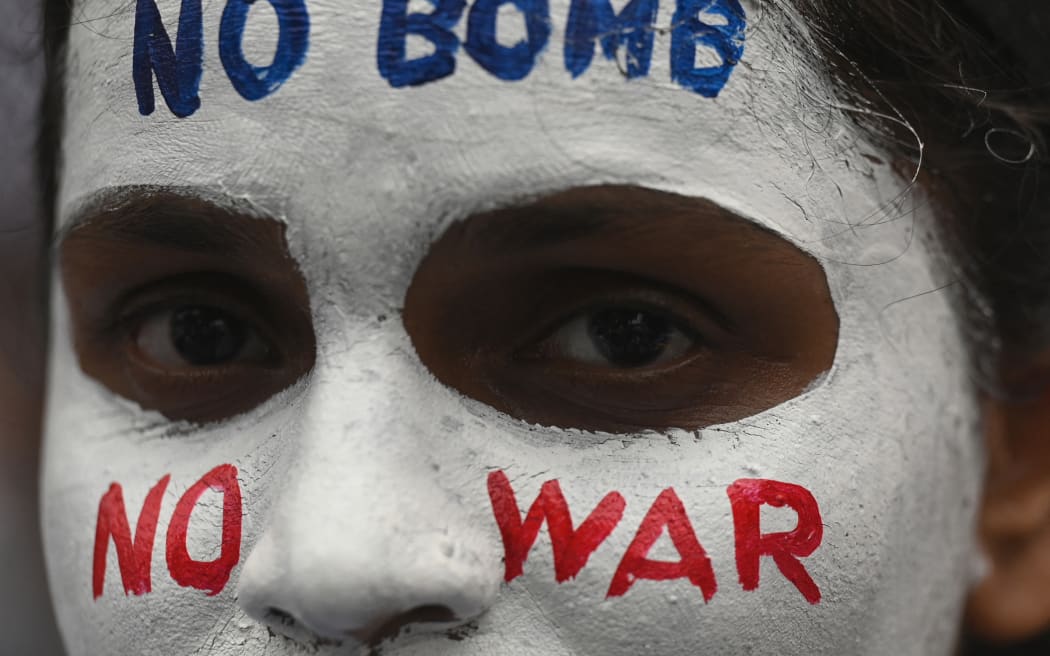 A woman participates in peace rally to mark the 78th anniversary of the atomic bombing of Hiroshima and Nagasaki at the end of WWII, in Mumbai on August 5, 2023. (Photo by Indranil MUKHERJEE / AFP)