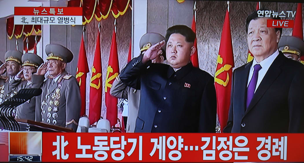 This screen grab taken from Yonhap News TV shows Kim Jong-Un (C) and Liu Yunshan (R).