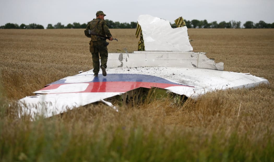 A pro-Russian separatist stands on part of the wreckage of the Malaysia Airlines  plane.