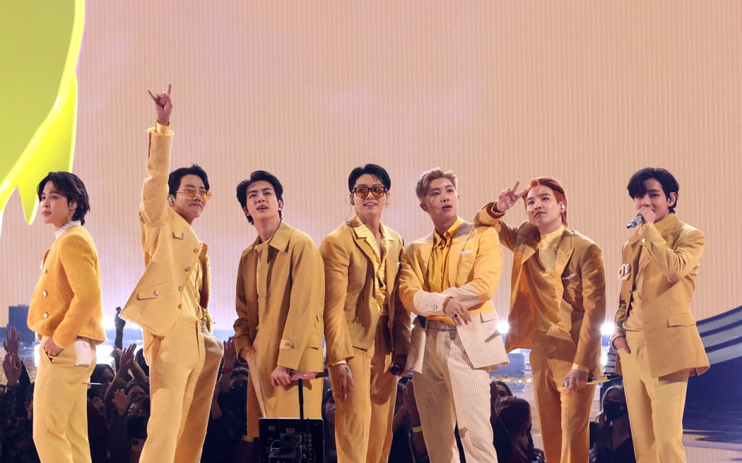 LOS ANGELES, CALIFORNIA - NOVEMBER 21: (L-R) Jimin, J-Hope, Jin, Jungkook, RM, Suga, and V of BTS perform onstage during the 2021 American Music Awards at Microsoft Theater on November 21, 2021 in Los Angeles, California.   Kevin Winter/Getty Images for MRC/AFP (Photo by KEVIN WINTER / GETTY IMAGES NORTH AMERICA / Getty Images via AFP)