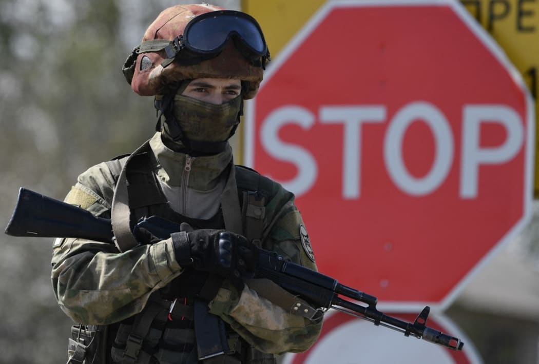 A Russian soldier stands guard at the site of the restoration of the North Crimean Canal in the Kherson region.