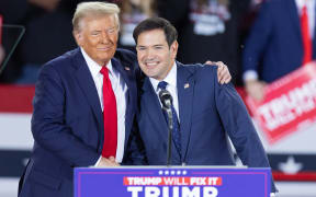 (FILES) Former US President and Republican presidential candidate Donald Trump greets Senator Marco Rubio, Republican of Florida, during a campaign rally at the J.S. Dorton Arena in Raleigh, North Carolina, on November 4, 2024. - President-elect Trump is expected to name Rubio as secretary of state, The New York Times reported late on November 11, 2024. It quoted three people as saying that the decision is not final, but that Trump appears to have settled on Rubio, a loyalist whom Trump passed over as his vice presidential running mate. (Photo by Ryan M. Kelly / AFP)