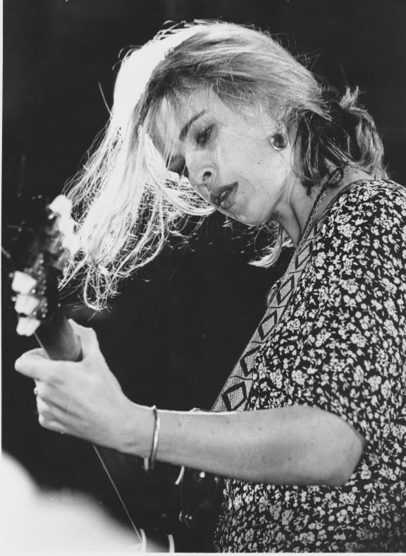 A black and white photograph of Jan Hellriegel playing at the Mountain Rock Festival in 1993.