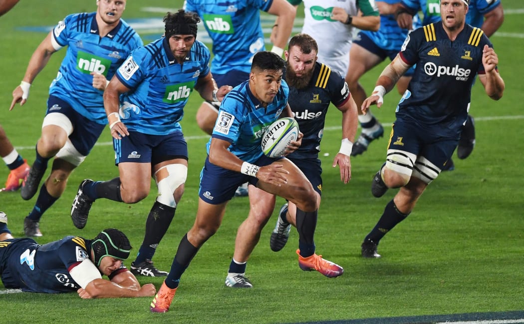 Blues wing Rieko Ioane leaves Highlanders defenders in his wake at Eden Park.