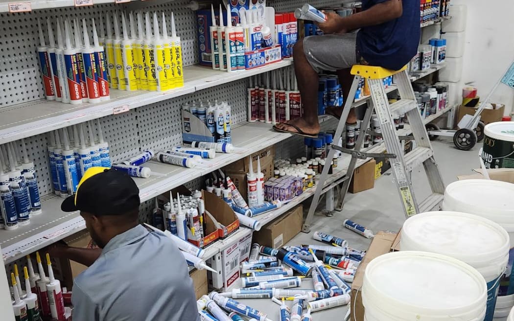 Santo Hardware workers clean up following magnitude-7 earthquake.