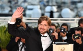 Swedish director Ruben Ostlund with the Palme d'Or for his film The Square, a satire on the art world.