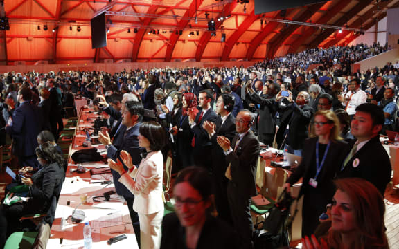 The UN Climate Change Conference breaks into cheers as the Paris Agreement in adopted on 13 December 2015 (NZT).