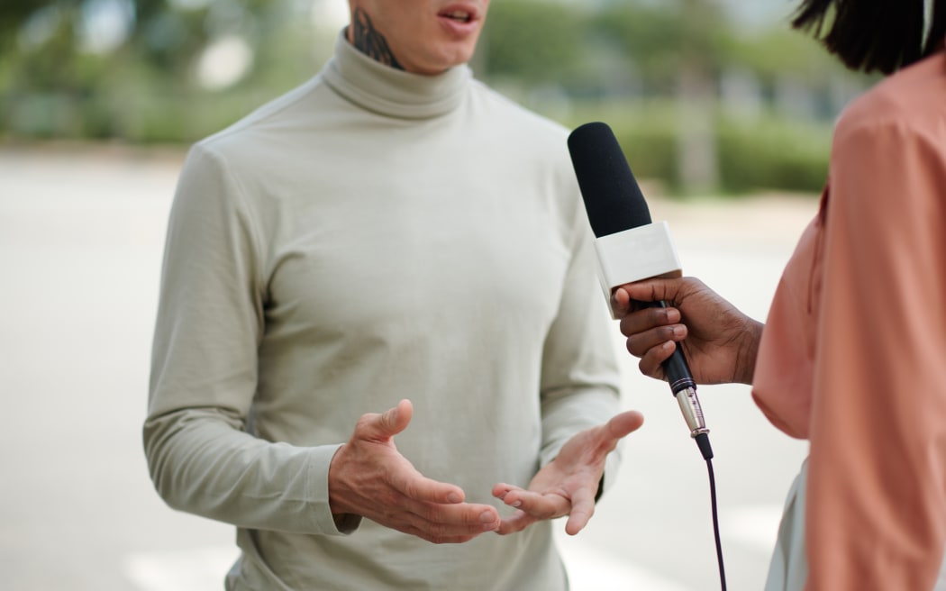 Cropped image of man answering questions of journalist