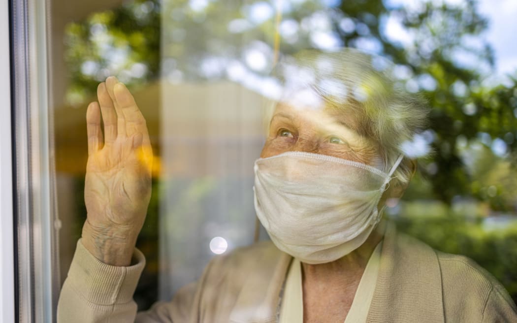 Elderly person in lockdown, isolation, isolate, Covid-19, mask, mental health.