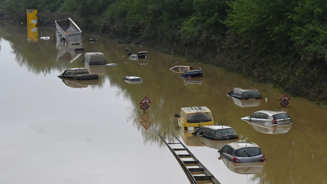 Submerged cars and other vehicles are seen on the federal highway B265 in Erftstadt, western Germany, on 17 July, 2021 after heavy rains hit parts of the country, causing widespread flooding and major damage.