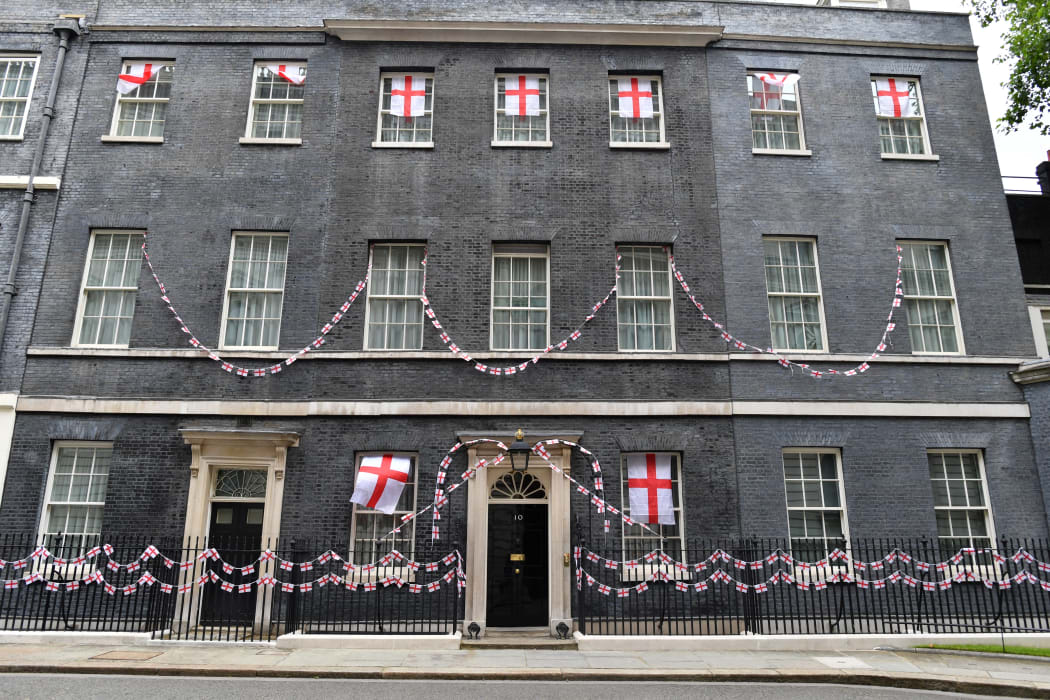 St George's flags, the national flag of England, flutter on the exterior of number 10, Downing Street in central London