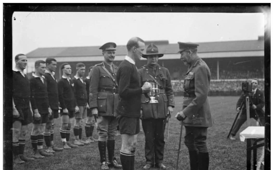 King George V presents the King's Cup to James Ryan, captain of the New Zealand Services Rugby Team, after the team's win in the Inter-Services Tournament at Twickenham rugby ground, London in 1919