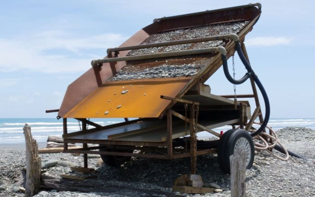 A metal sluice box for extracting alluvial gold dust from a gravel beach on the West Coast.