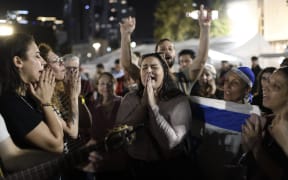 Israelis are reacting at the ''Hostages Square'' outside the Art Museum of Tel Aviv as the first group of Israeli hostages safely returns to Israel in Tel Aviv, Israel, on November 24, 2023. (Photo by Gili Yaari/NurPhoto) (Photo by Gili Yaari / NurPhoto / NurPhoto via AFP)
