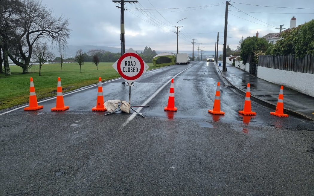 A police cordon blocking off Eglinton Road in Dunedin where a man died.