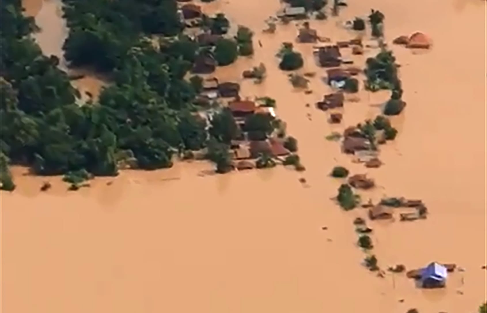 This screen grab taken on handout video footage from ABC Laos on July 24, 2018 shows an aerial view of the flooded plains in Attapeu province after a dam collapsed the day before.