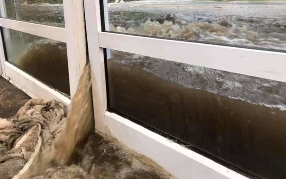 Floodwaters pour into the Milford Visitors' Terminal on Monday