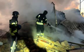 In this handout photograph taken and released by the Ukrainian Emergency Service on November 28, 2024, Ukrainian rescuers work to extinguish a fire at an energy infrastructure facility following a missile attack in Lutsk, Volyn region, amid the Russian invasion of Ukraine. - More than a million Ukrainians were left without power in freezing cold temperatures on November 28, 2024 after a massive nationwide Russian missile and drone attack. (Photo by Handout / UKRAINIAN EMERGENCY SERVICE / AFP) / RESTRICTED TO EDITORIAL USE - MANDATORY CREDIT "AFP PHOTO / UKRAINIAN EMERGENCY SERVICE" - NO MARKETING NO ADVERTISING CAMPAIGNS - DISTRIBUTED AS A SERVICE TO CLIENTS
