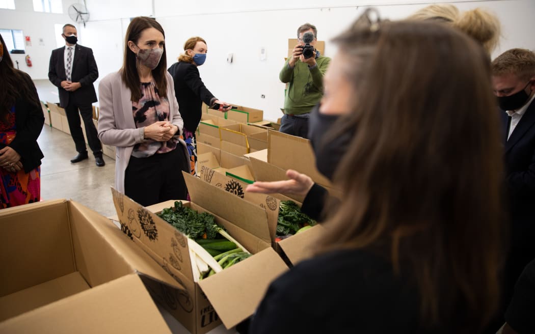 Jacinda Ardern at BBM HQ in Manukau looking at and packing food parcels.