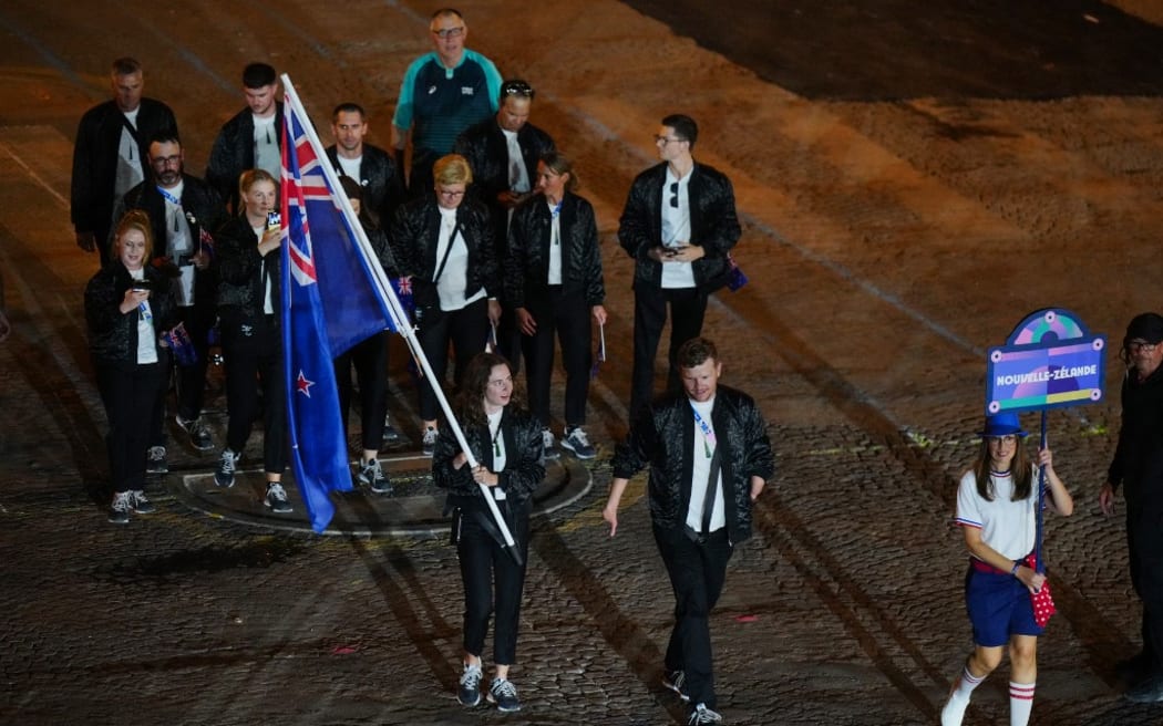 New Zealand's delegation parades on the Champs-Elysees avenue during the Paris 2024 Paralympic Games Opening Ceremony in Paris on August 28, 2024. (Photo by Dimitar DILKOFF / AFP)