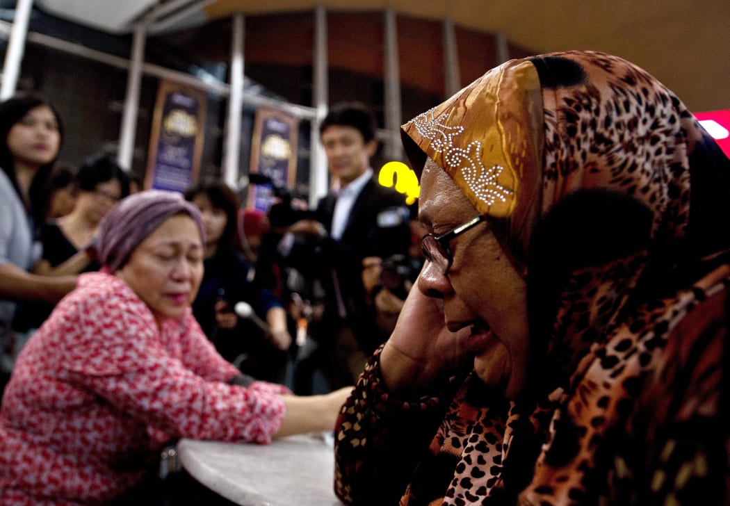 Relatives of passengers on flight MH17 from Amsterdam outside the family holding area at the Kuala Lumpur International Airport in Sepang.