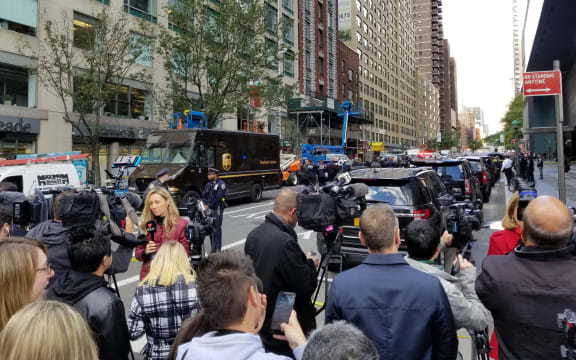 Police officers take security measures in front of the Time Warner Building where a suspected explosive device was found in the building after it was delivered to CNN's New York bureau in New York.
