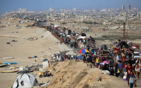 Displaced Palestinians move with their belongings southwards on a road in the Nuseirat refugee camp area in the central Gaza Strip following renewed Israeli evacuation orders for Gaza City on 16 September, 2025. Israel launched its long-anticipated ground assault on Gaza City at dawn, a day after winning backing from its top ally the United States despite mounting international alarm.