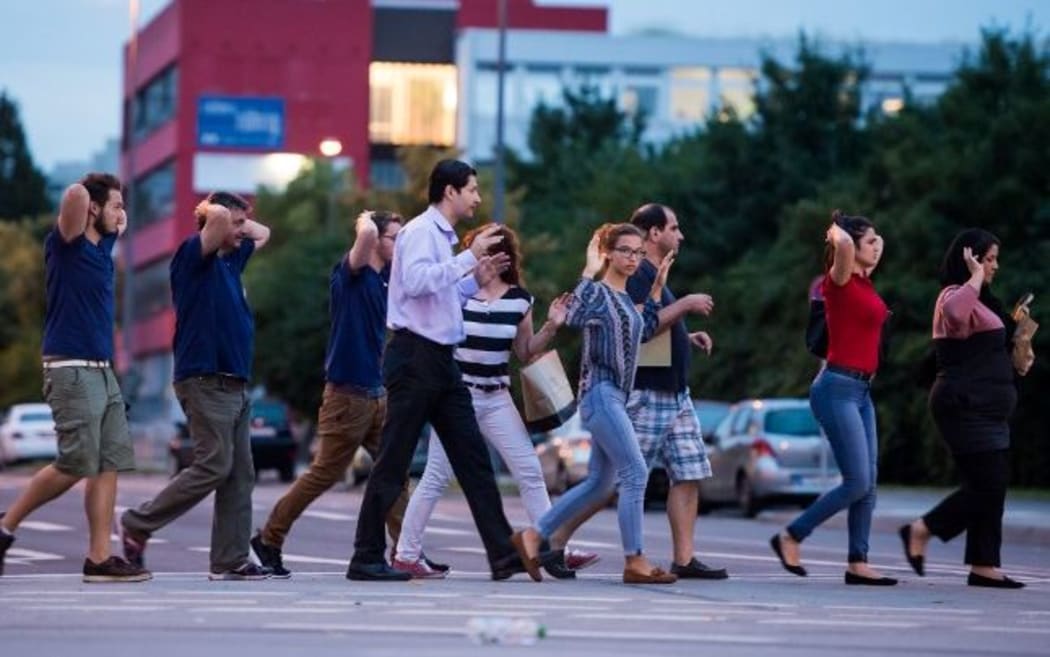 People are evacuated from the shopping mall following the shooting.