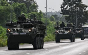 Royal Thai Army soldiers are pictured on armoured vehicles on a road in Chachoengsao province on 24 July, 2025.