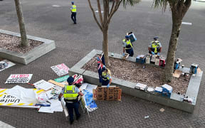 Police on Molesworth Street in Wellington clearing protesters' signs from the streets.